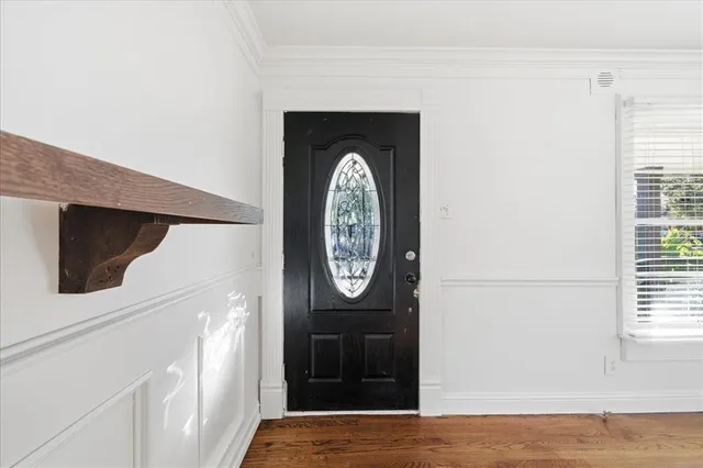 wooden floor in an empty room with a window