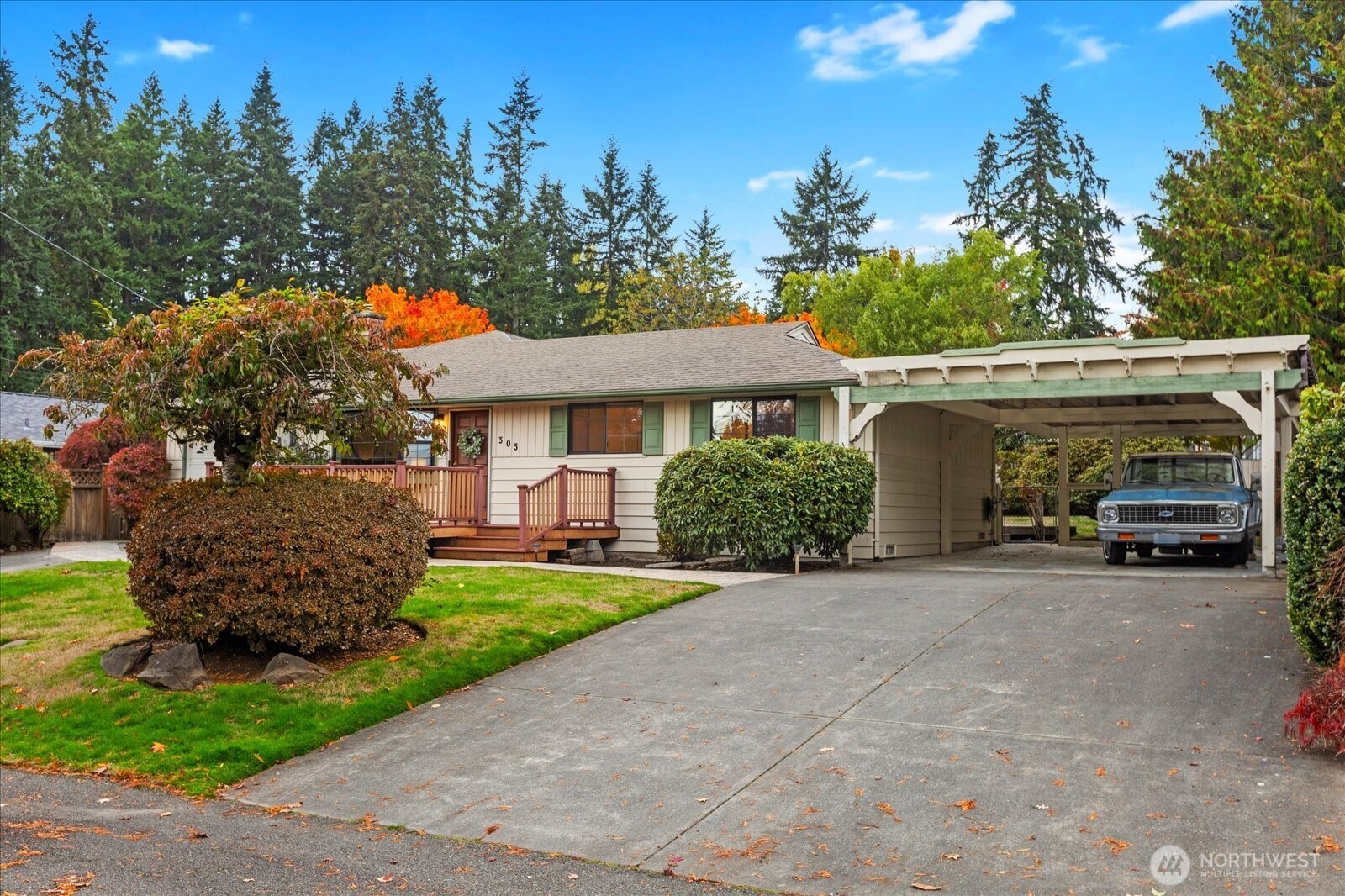 305 234th Street Southwest Bothell, WA 98021 - Photo 34 of 40 a view of a house with a garden and parking area