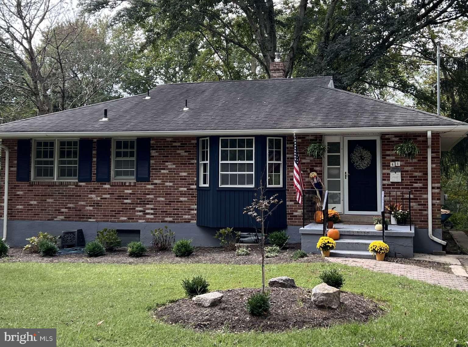 a front view of a house with garden and porch