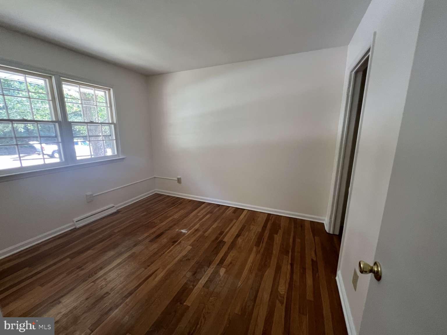 41 Fremont Road Newark, DE 19711 - Photo 14 of 25 an empty room with wooden floor and windows