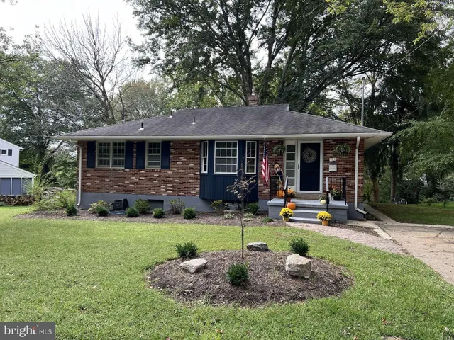 a front view of a house with a yard table and chairs