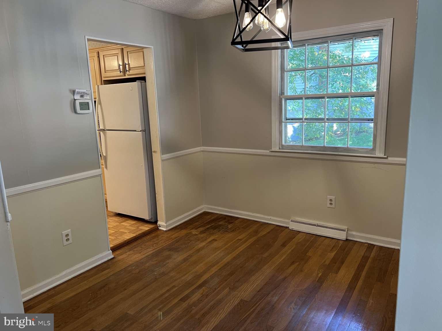 41 Fremont Road Newark, DE 19711 - Photo 5 of 25 an empty room with wooden floor and windows