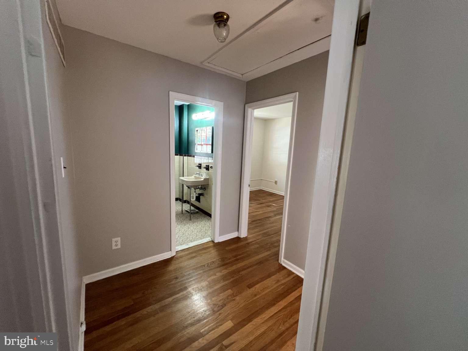 41 Fremont Road Newark, DE 19711 - Photo 9 of 25 a view of a hallway with wooden floor and a bathroom