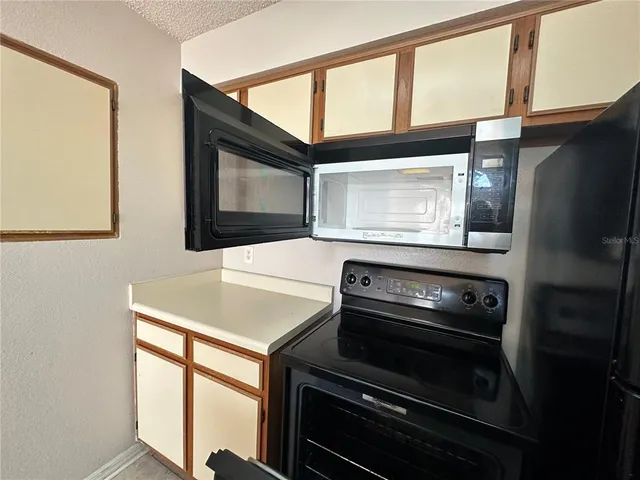 a kitchen with a stove and a microwave