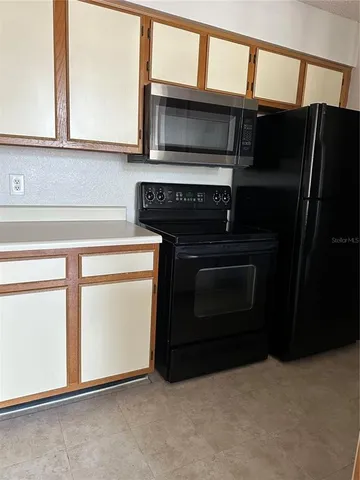 a kitchen with a stove and a microwave