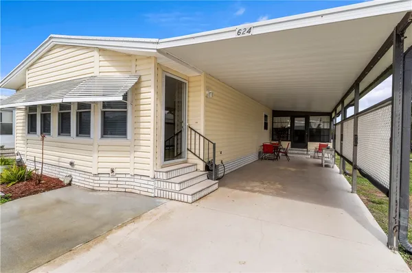 a bedroom with a large bed and chandelier