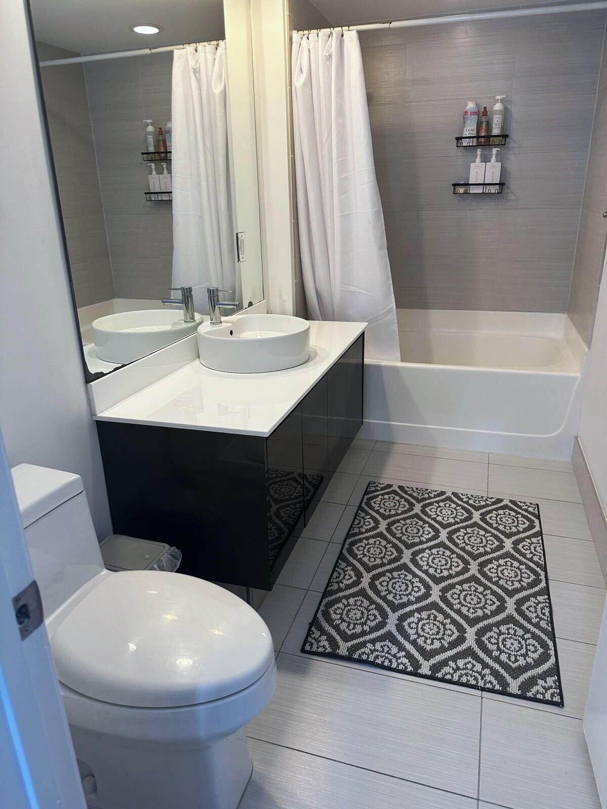 31 Southeast 6th Street, Unit 602 Miami, FL 33131 - Photo 12 of 39 a bathroom with a sink toilet and shower