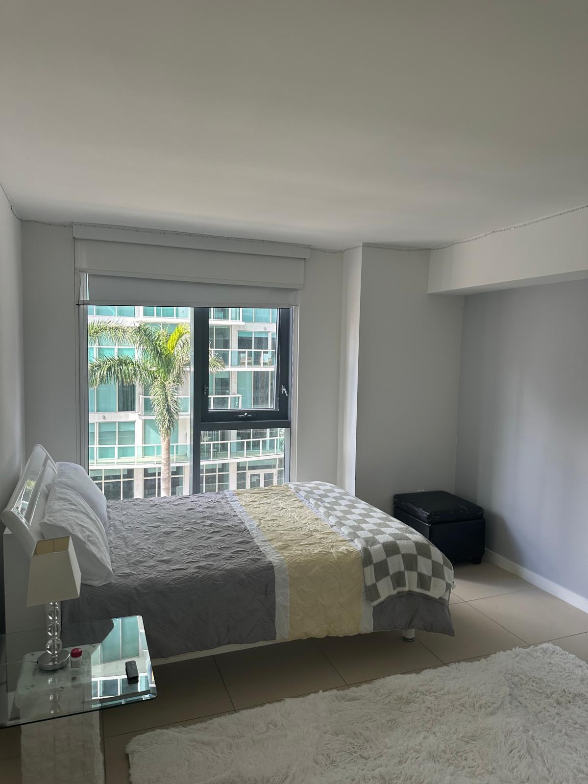 31 Southeast 6th Street, Unit 602 Miami, FL 33131 - Photo 14 of 39 a bedroom with a bed and glass window