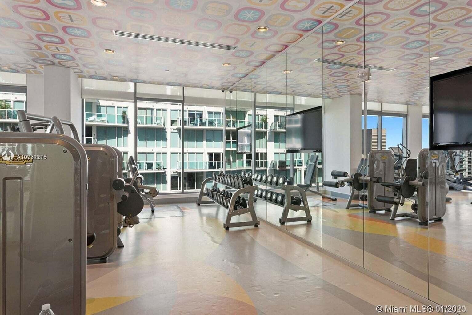 31 Southeast 6th Street, Unit 602 Miami, FL 33131 - Photo 23 of 39 a living room with lots of furniture and a flat screen tv