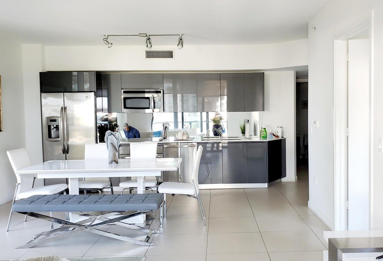 31 Southeast 6th Street, Unit 602 Miami, FL 33131 - Photo 6 of 39 a living room with stainless steel appliances kitchen island granite countertop furniture and a view of kitchen