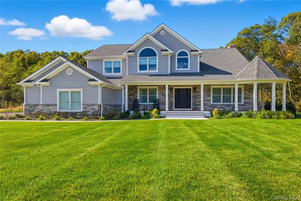 a front view of a house with a garden and patio