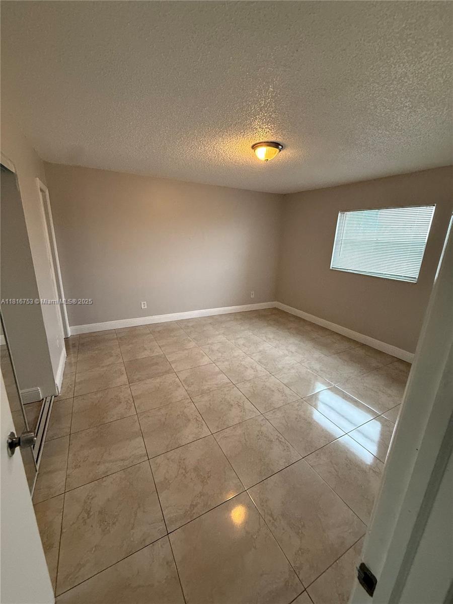 4121 Stirling Road, Unit 402 Dania Beach, FL 33314 - Photo 6 of 10 a view of an empty room with a window