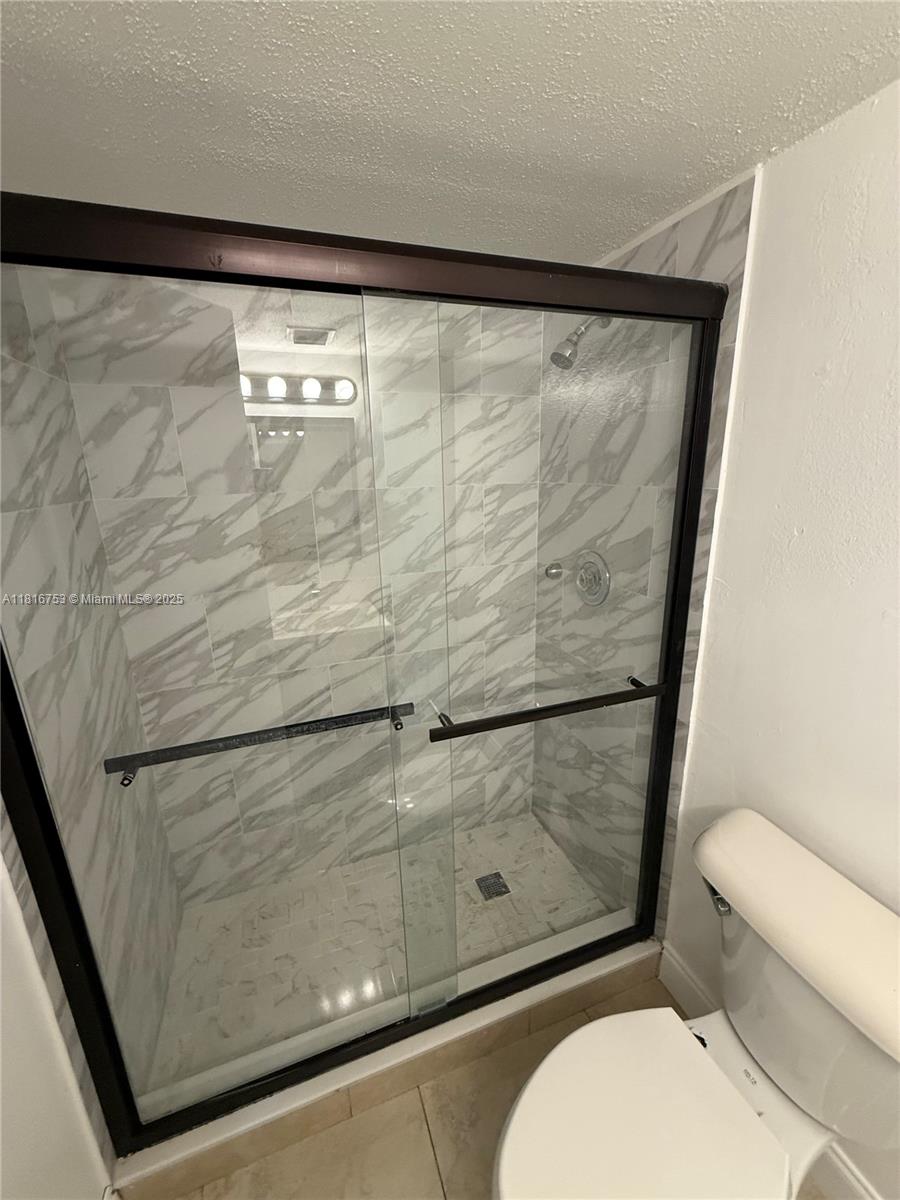 4121 Stirling Road, Unit 402 Dania Beach, FL 33314 - Photo 10 of 10 a bathroom with a toilet and a shower