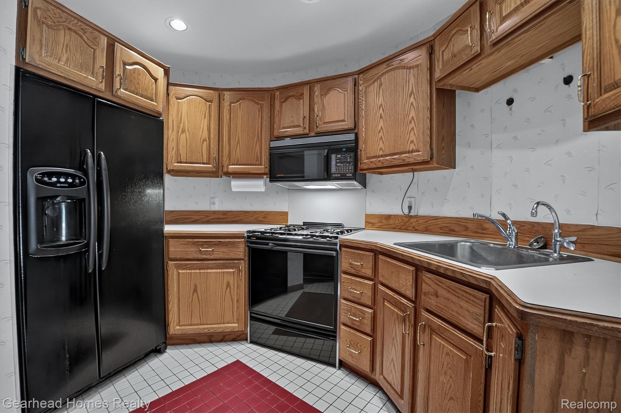 3486 West Drahner Road Oxford, MI 48371 - Photo 11 of 51 Kitchen featuring wood-finish cabinetry and white countertops