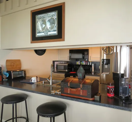 a living room with furniture a flat screen tv and a large window