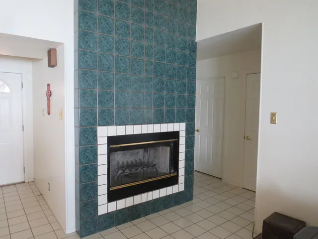 a living room with furniture and floor to ceiling windows