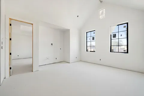 a view of a tennis ground with large trees