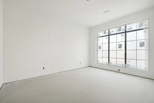 an empty room with grey walls