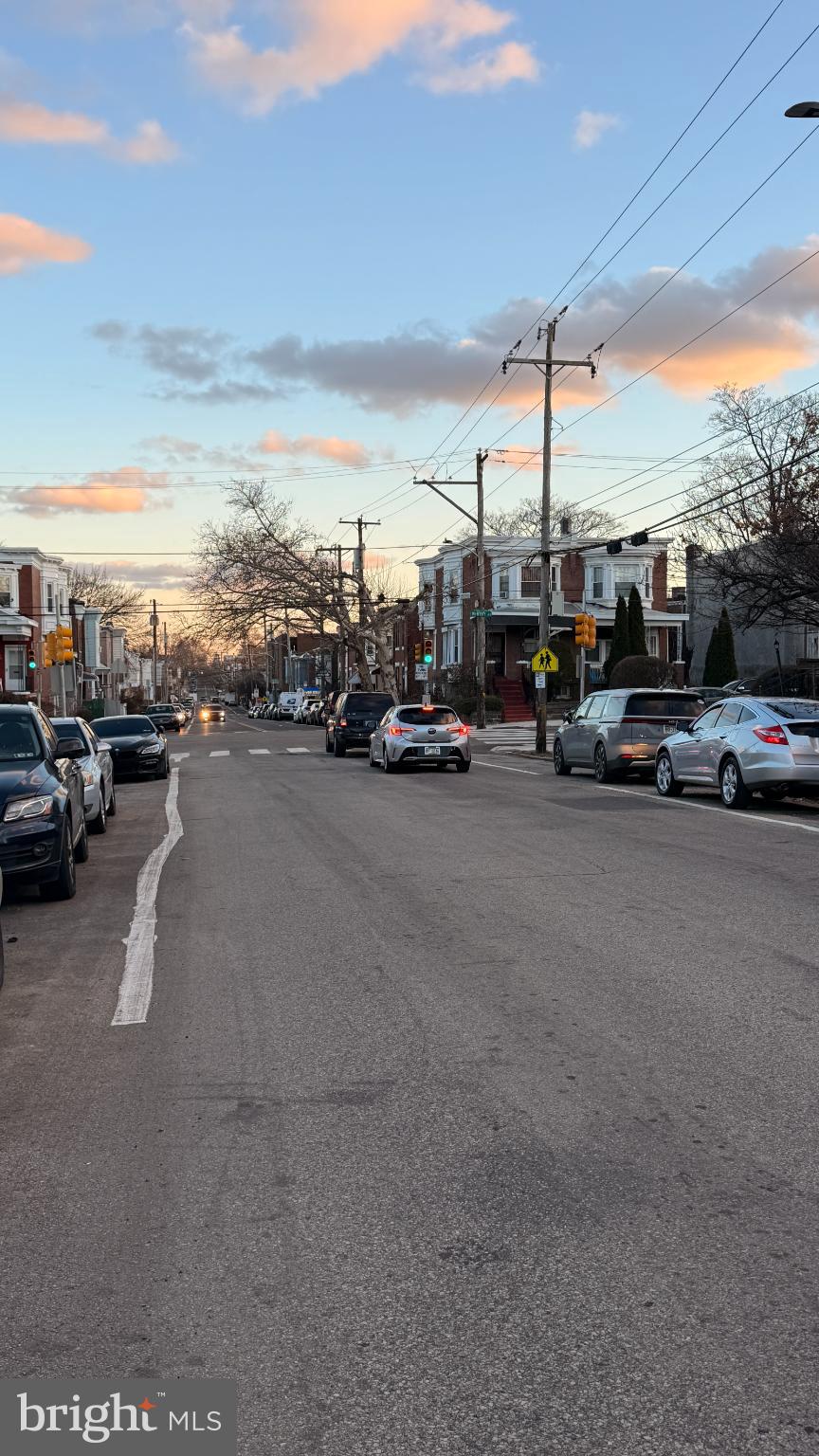 1322 South 57th Street Philadelphia, PA 19143 - Photo 9 of 9 Quiet street at dusk, lined with cars.