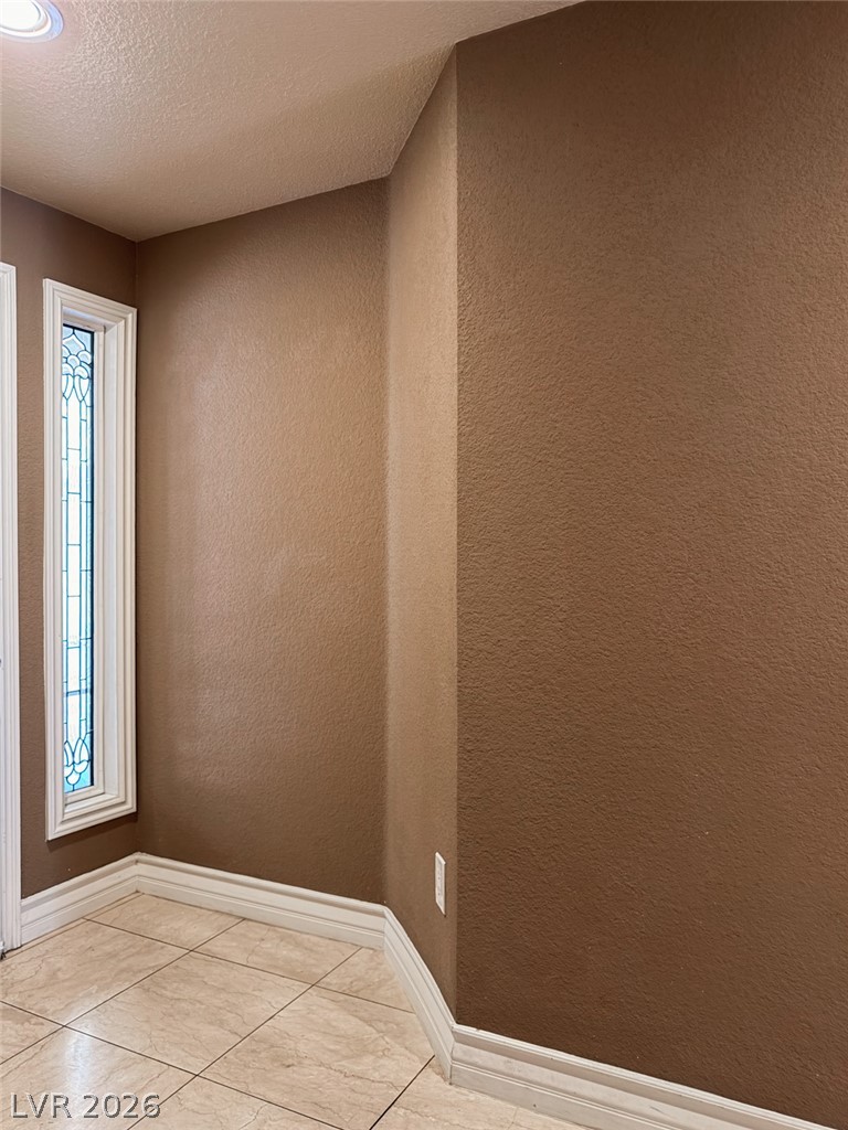 210 East Flamingo Road, Unit 112 Las Vegas, NV 89169 - Photo 11 of 59 A quiet corner near the entryway showcases textured walls and neutral tile flooring.