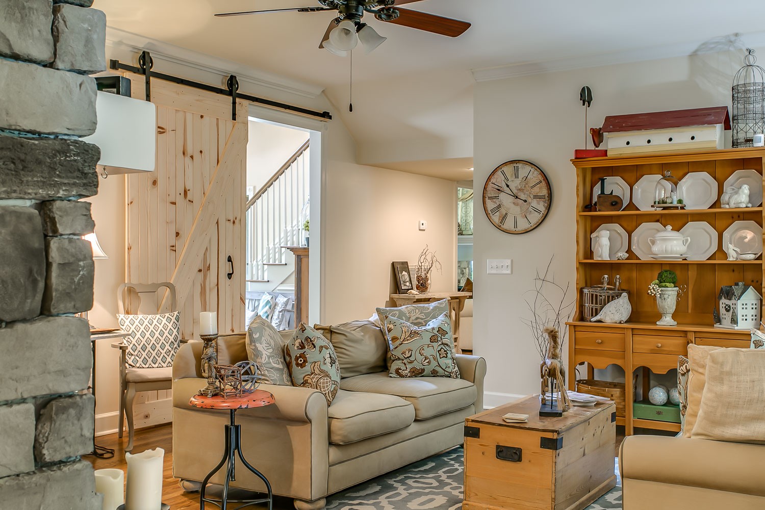128 Deejay Drive Franklin, TN 37064 - Photo 20 of 50 a living room with furniture a clock on wall and a table