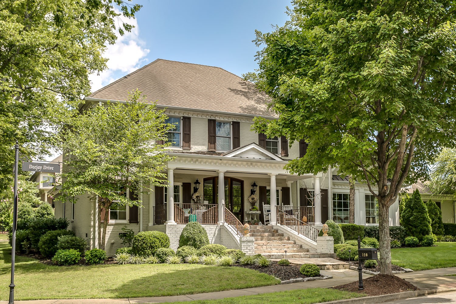 128 Deejay Drive Franklin, TN 37064 - Photo 2 of 50 a front view of a house with a yard table and chairs