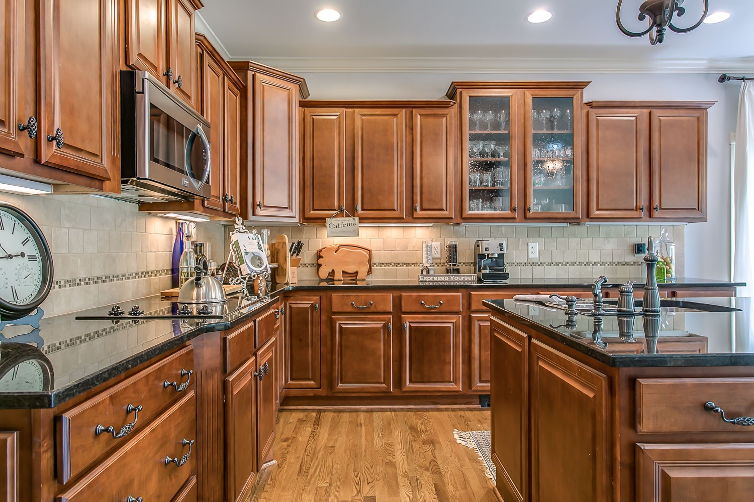 128 Deejay Drive Franklin, TN 37064 - Photo 27 of 50 a kitchen with stainless steel appliances granite countertop a sink stove and cabinets