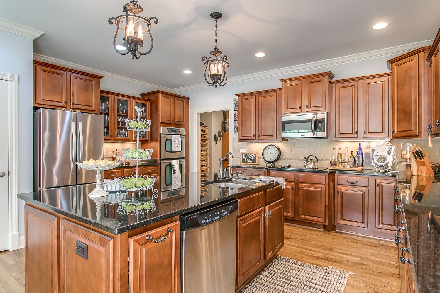 128 Deejay Drive Franklin, TN 37064 - Photo 28 of 50 a kitchen with stainless steel appliances granite countertop a sink and cabinets