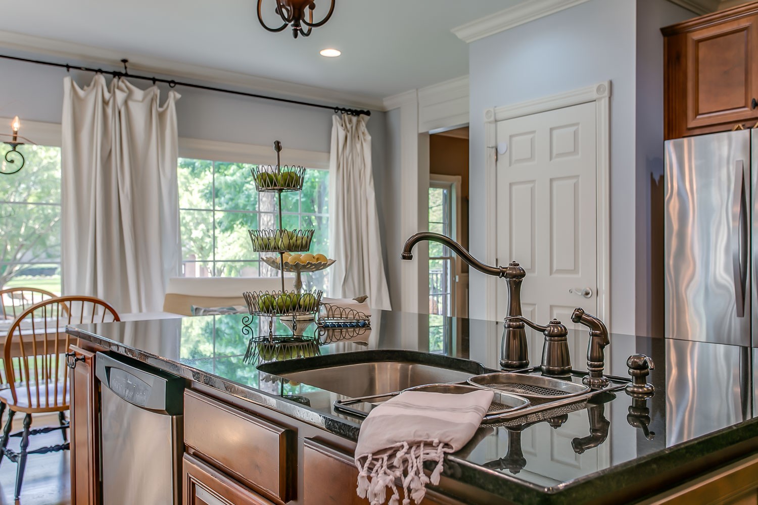 128 Deejay Drive Franklin, TN 37064 - Photo 31 of 50 a kitchen with stainless steel appliances granite countertop a stove a sink and a refrigerator