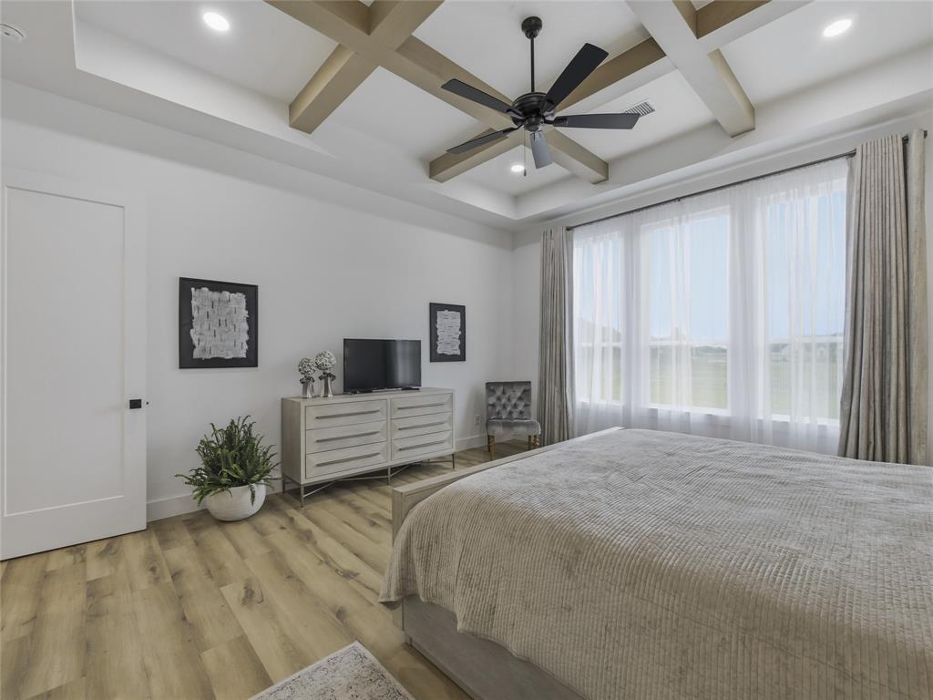 4211 Azalea Way Midlothian, TX 76065 - Photo 19 of 39 Spacious room featuring wood-finish flooring, a tray ceiling with exposed wood-look beams, and a ceiling fan with integrated lighting
