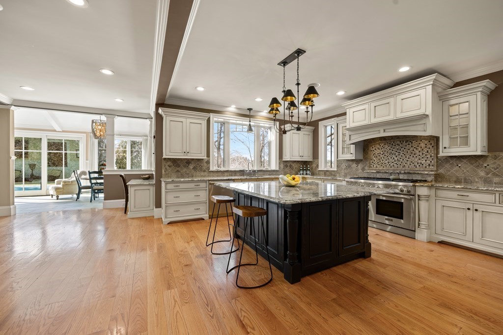 204 Cedar Street Lexington, MA 02421 - Photo 12 of 42 a kitchen with stainless steel appliances granite countertop a sink dishwasher stove and oven with wooden floor