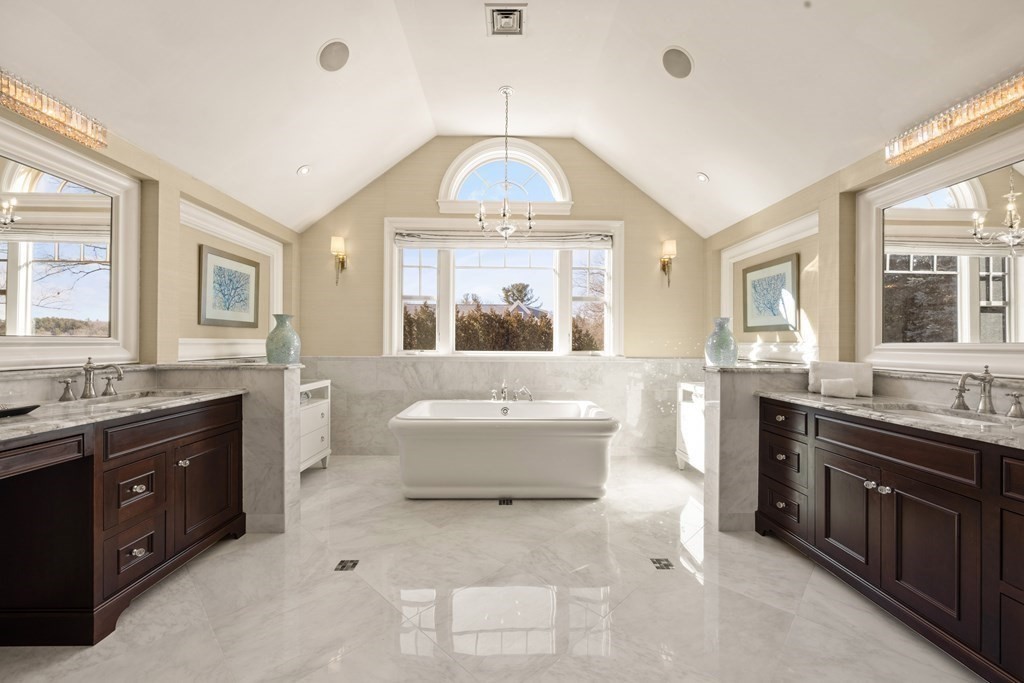 204 Cedar Street Lexington, MA 02421 - Photo 26 of 42 a spacious bathroom with a granite countertop tub a double vanity sink a window and a mirror