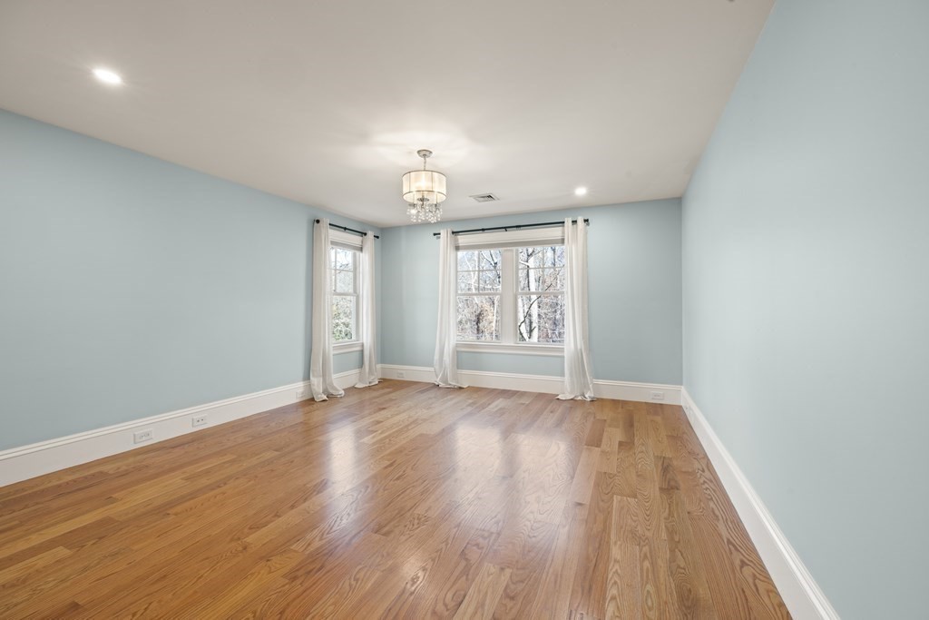 204 Cedar Street Lexington, MA 02421 - Photo 29 of 42 an empty room with wooden floor and windows