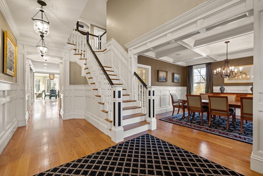 204 Cedar Street Lexington, MA 02421 - Photo 3 of 42 a living room with lots of wooden furniture and a chandelier
