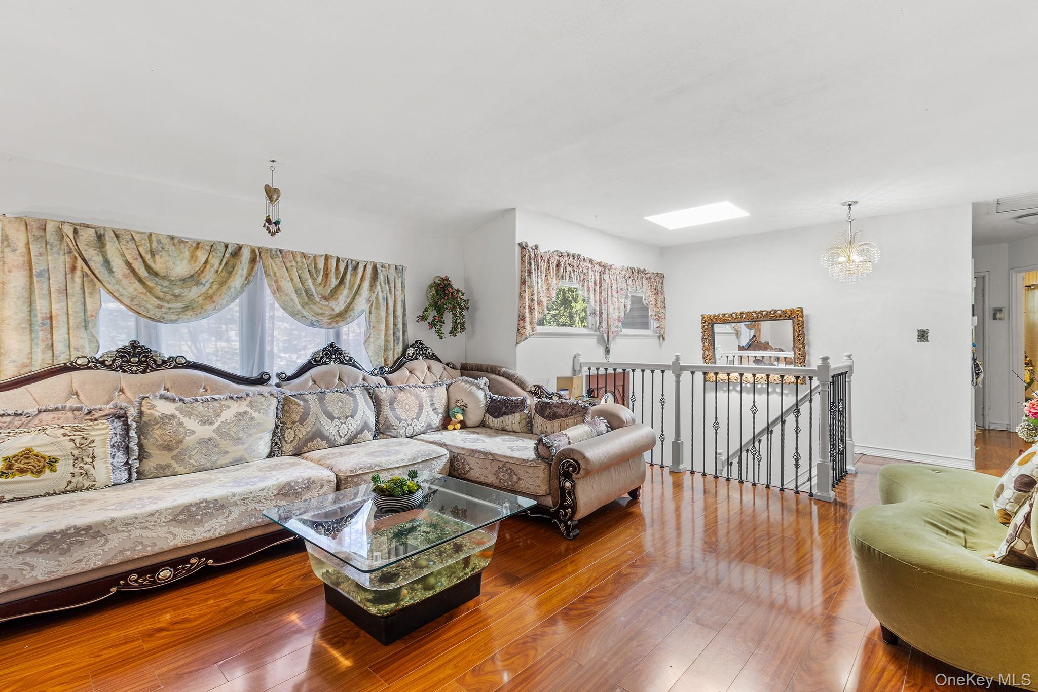 31 Holbrook Road Centereach, NY 11720 - Photo 11 of 27 a living room with furniture and wooden floor
