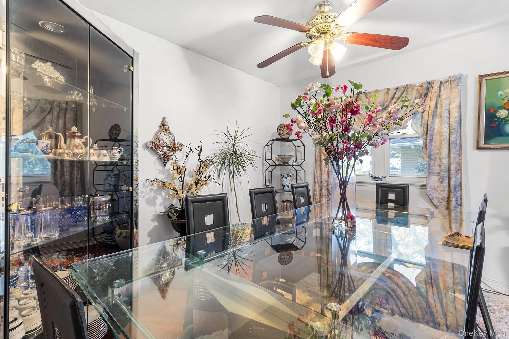 31 Holbrook Road Centereach, NY 11720 - Photo 14 of 27 a dining room with furniture a fireplace and chandelier