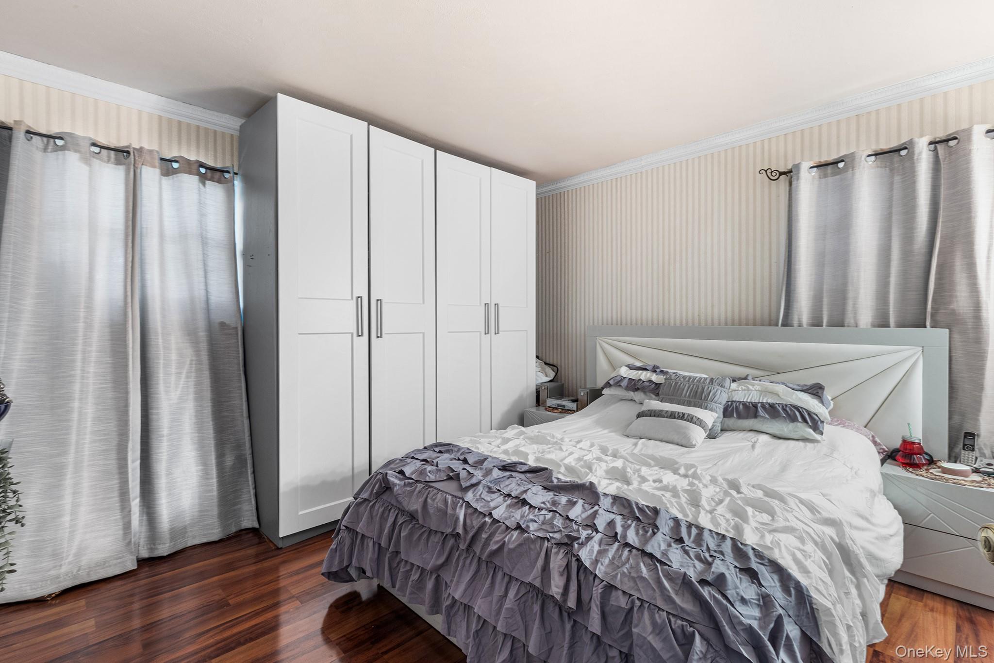 31 Holbrook Road Centereach, NY 11720 - Photo 17 of 27 a bedroom with a bed and a mirror