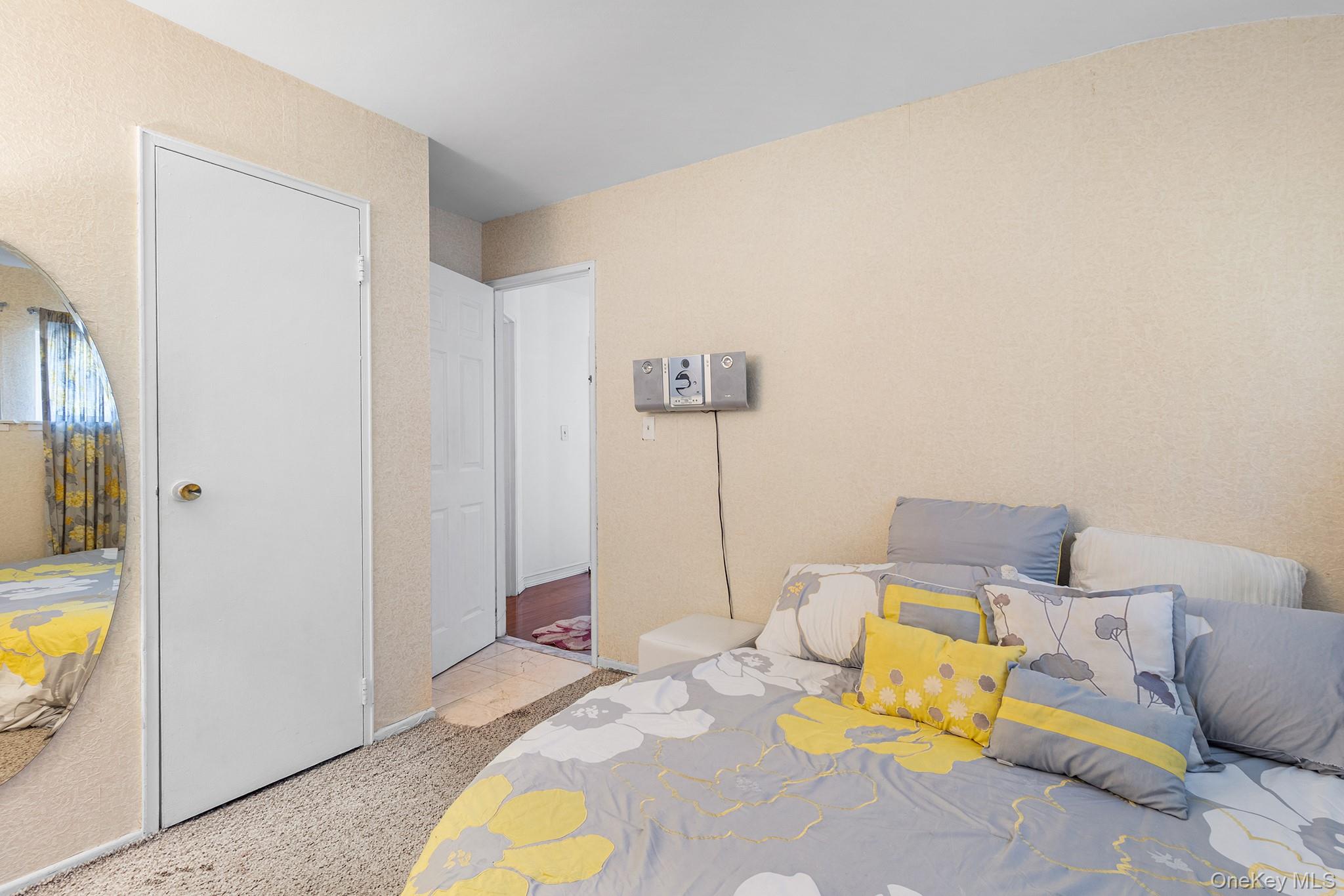 31 Holbrook Road Centereach, NY 11720 - Photo 20 of 27 a bed room with a bed and a couch