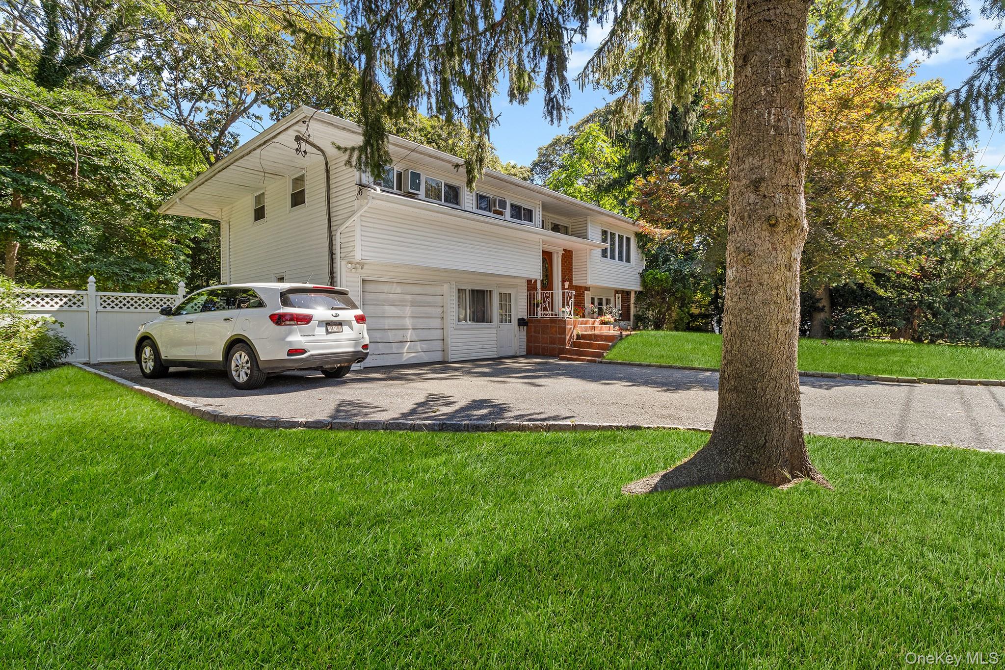 31 Holbrook Road Centereach, NY 11720 - Photo 2 of 27 a view of a car parked in front of a house