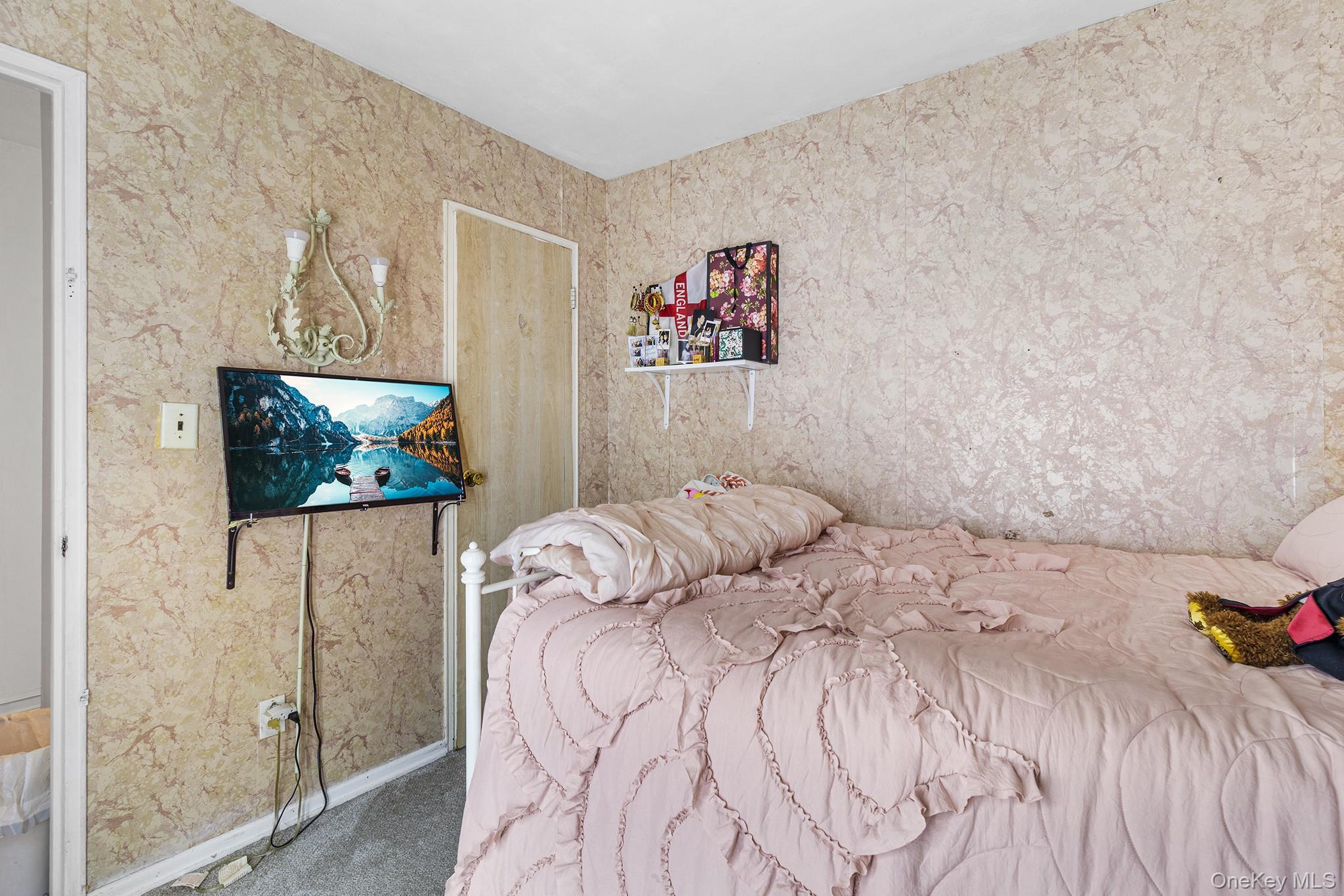 31 Holbrook Road Centereach, NY 11720 - Photo 22 of 27 a bedroom with a bed and a wall painting