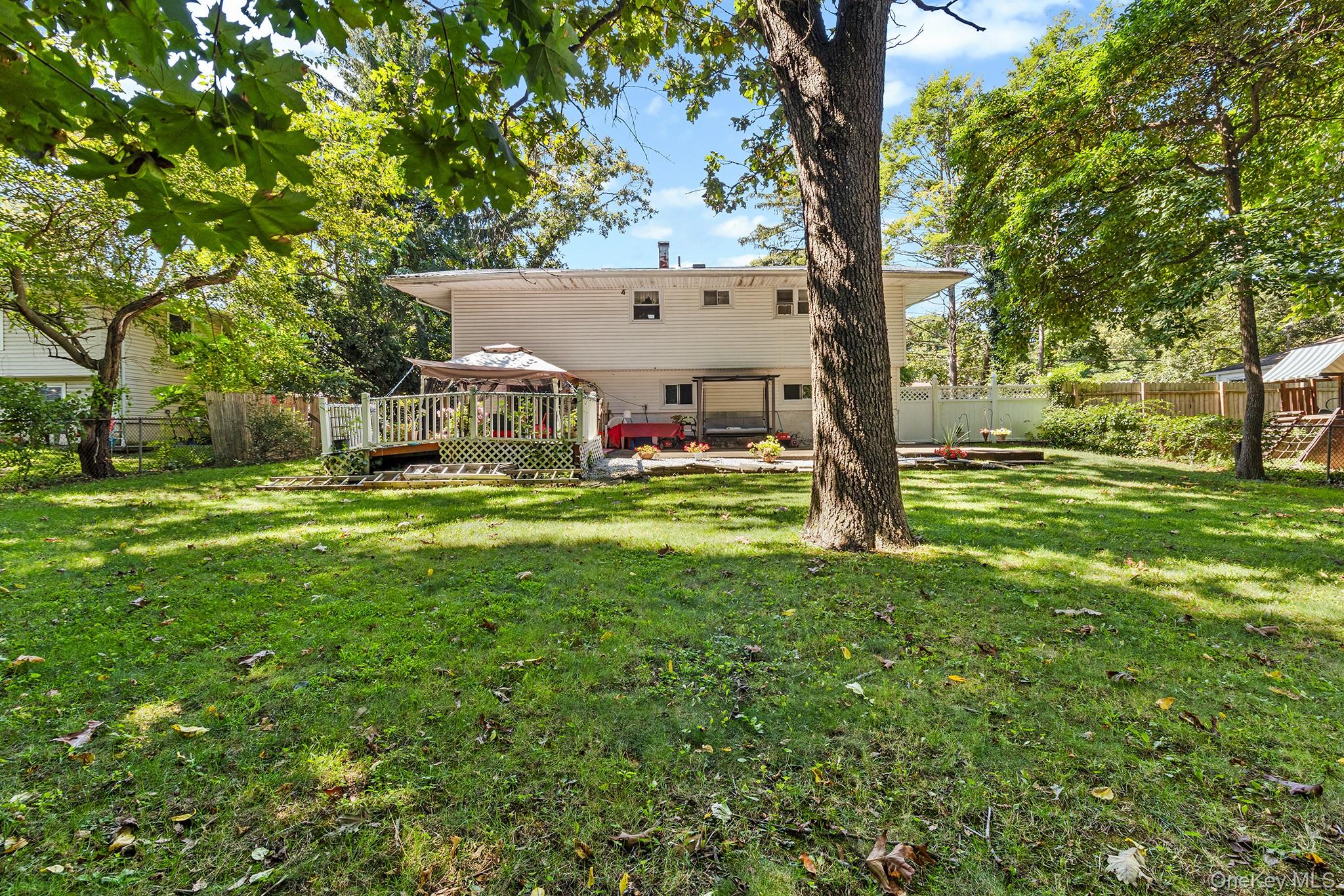 31 Holbrook Road Centereach, NY 11720 - Photo 23 of 27 a view of a house with a yard