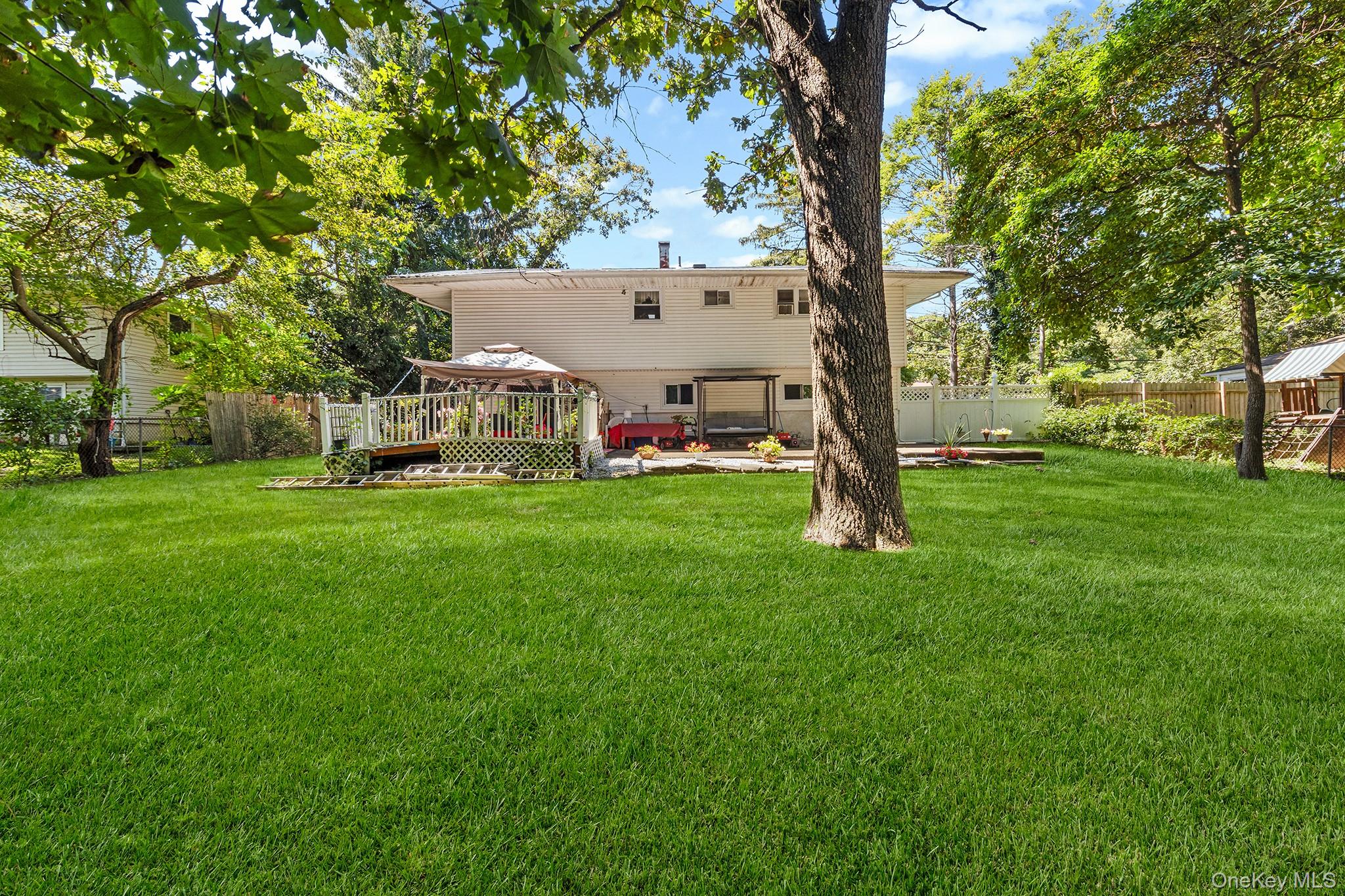 31 Holbrook Road Centereach, NY 11720 - Photo 24 of 27 a view of a house with a yard