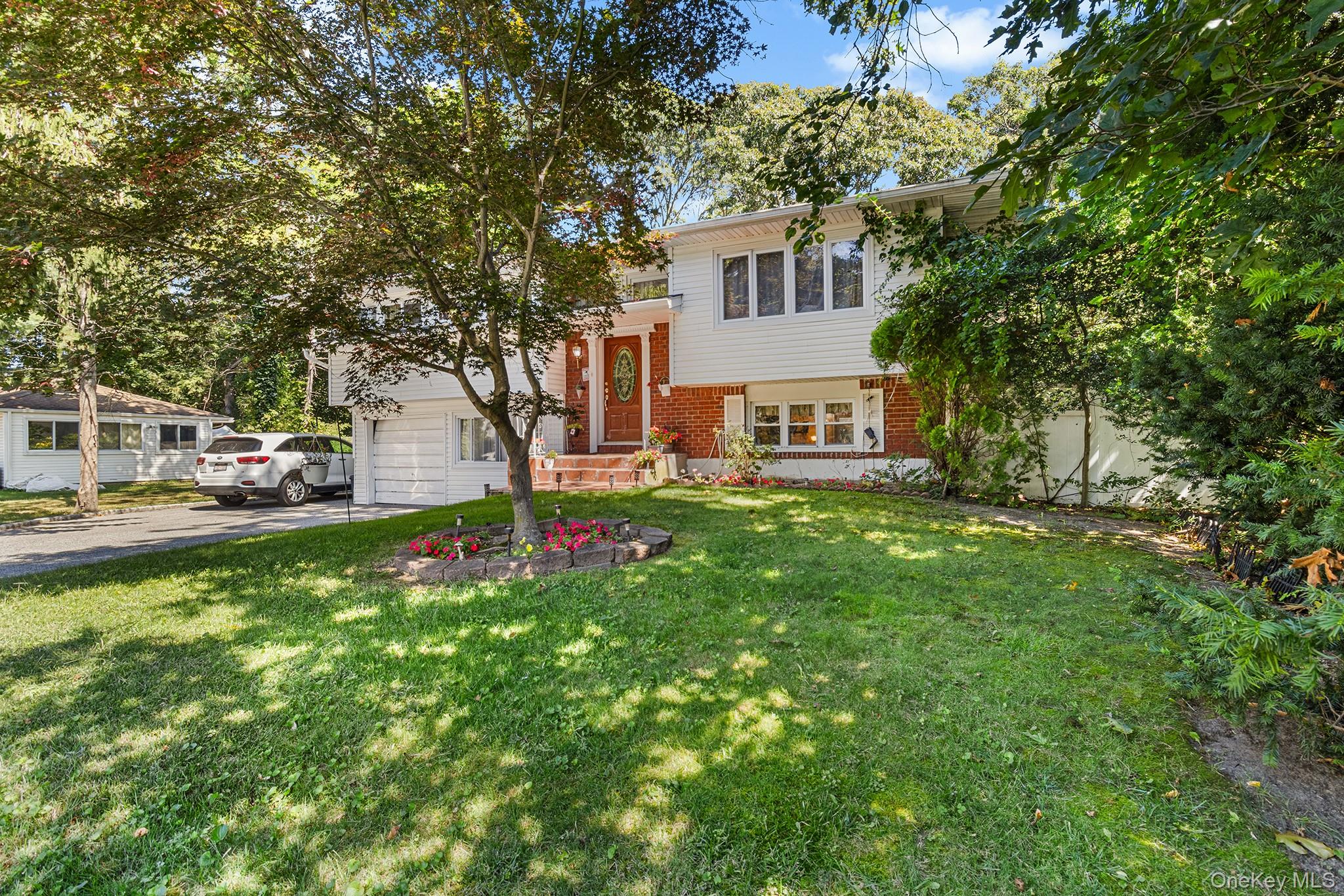 31 Holbrook Road Centereach, NY 11720 - Photo 3 of 27 a front view of a house with garden