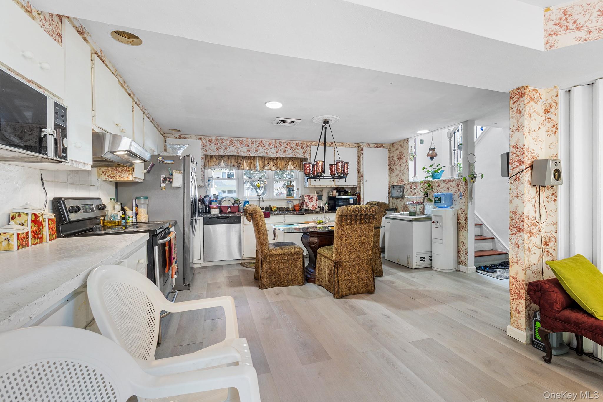 31 Holbrook Road Centereach, NY 11720 - Photo 4 of 27 a living room with stainless steel appliances kitchen island granite countertop furniture and a view of kitchen