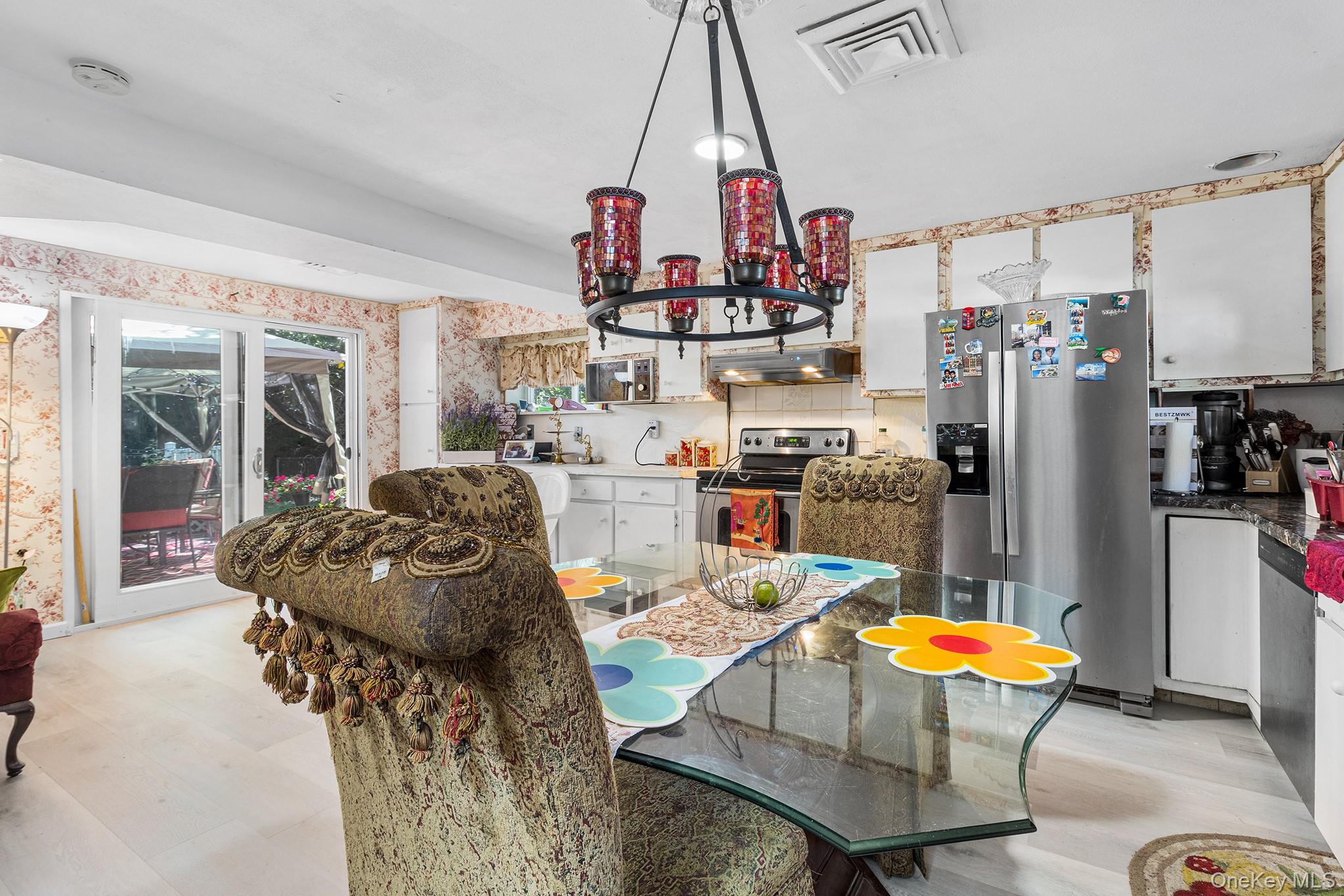 31 Holbrook Road Centereach, NY 11720 - Photo 6 of 27 a kitchen with stainless steel appliances granite countertop a refrigerator and microwave