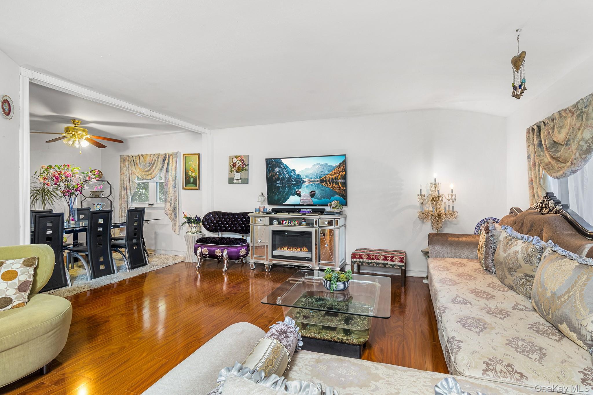 31 Holbrook Road Centereach, NY 11720 - Photo 9 of 27 a living room with furniture and a flat screen tv