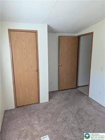 an empty room with closet area