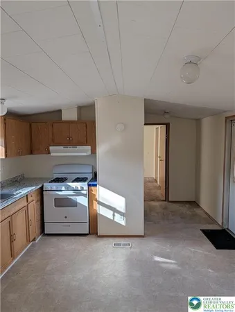 a kitchen with stainless steel appliances granite countertop a sink and a stove top oven