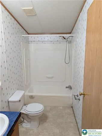 a bathroom with a toilet and shower