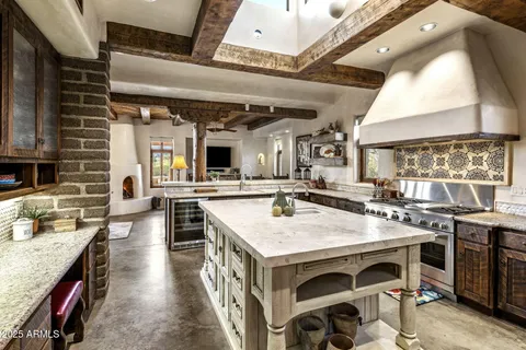 a kitchen with stainless steel appliances granite countertop a stove a sink and a refrigerator